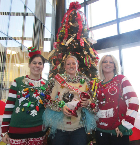 Allan Blanks/MDN In the center, Beth Pietsch, the winner of the 2016 ugly sweater contest stands between finalists Kerri Tyler and Kristin Kowalczyk. More than a dozen competitors took part in the